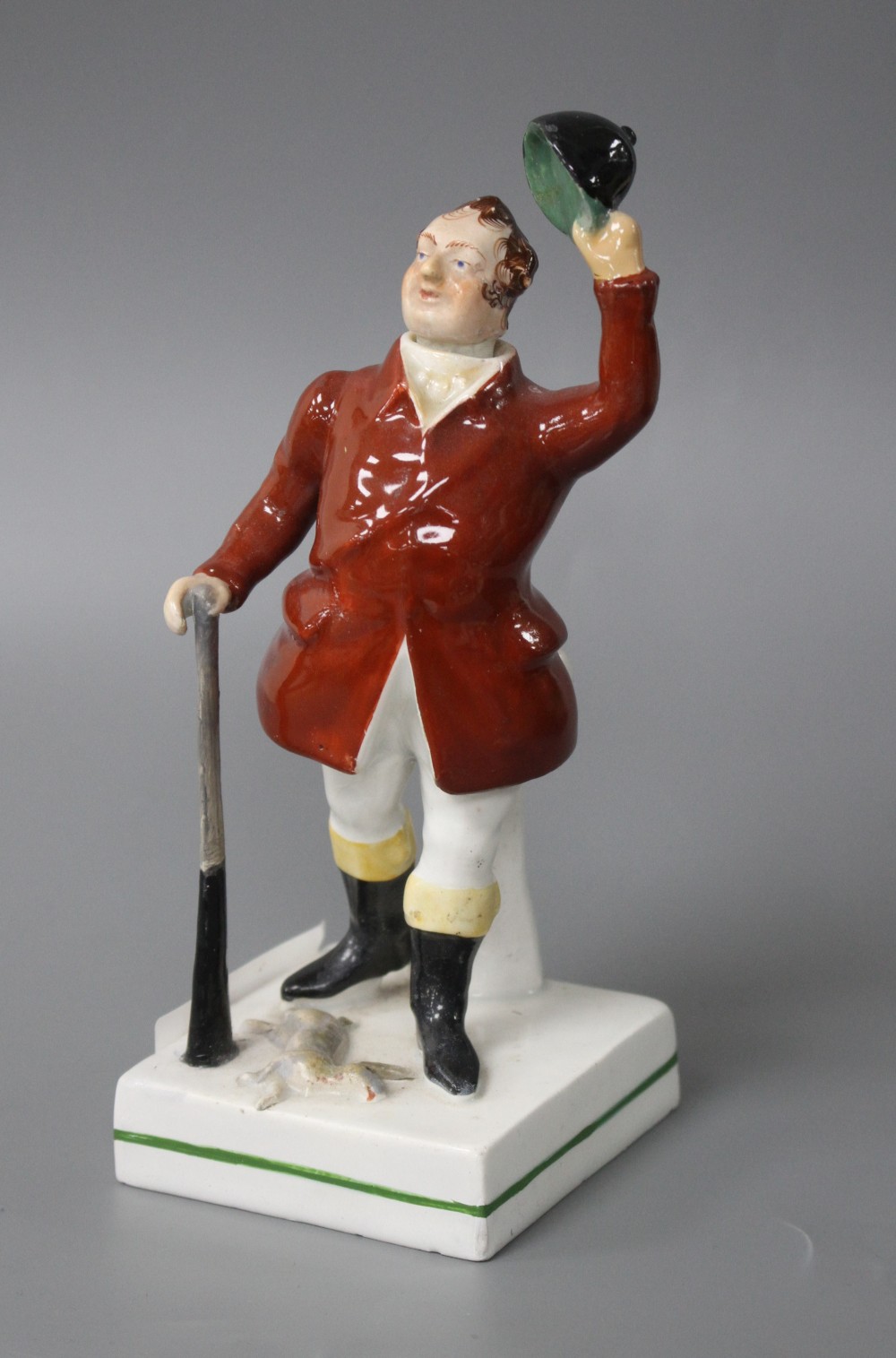 A 19th century Staffordshire figure of a huntsman with stoppered head and square base, height 17cm